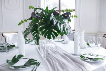 Wedding served table setting of palm tree leaves