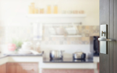 opened wooden door to modern kitchen interior as background