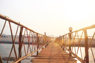 Naklejka premium Wooden bridge across the river