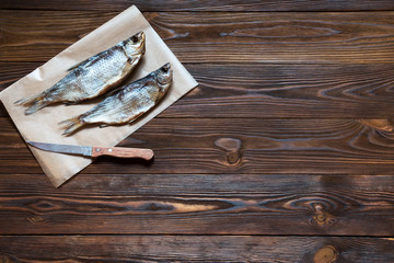 cloce-up dried fish and knife on a black background