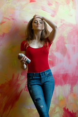 Fototapeta premium Pretty girl or beautiful painter with spray paint bottle
