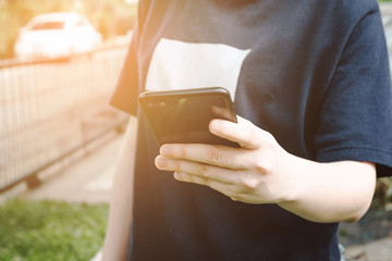 Close up young woman using mobile smart phone outdoor.