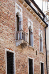 Fototapeta na wymiar wall of medieval palazzo on street contra porti