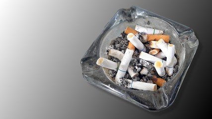 Ashtray and butted out cigarettes isolated on gradient grey  background