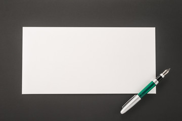   Envelope with a pen on a black background
