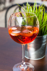 glass of Spritz cocktail with ice on table