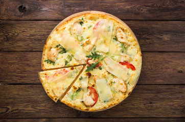 Delicious pizza with chicken, parmesan and fresh arugula