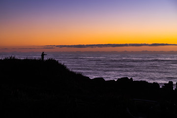 Silhouette of man stand at the coat around Punakaiki Pancake Rocks and Blowholes, West Coast, New Zealand