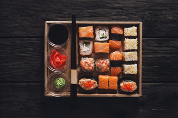 Set of sushi maki and rolls at black rustic wood. © Prostock-studio