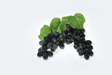 Wine grapes with leaves isolated on white background