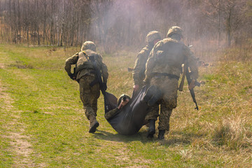 Military bear his wounded friend