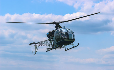 Fototapeta na wymiar helicopter fly near the forest