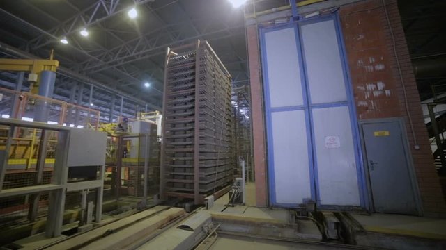 Industrial rack with bricks moves at a furnace, production shop of plant. HD.