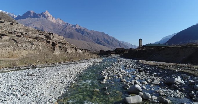 Camera moves over river in mountain valley