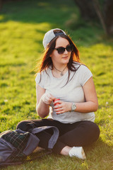 Pretty girl drink coda at park background with sunset