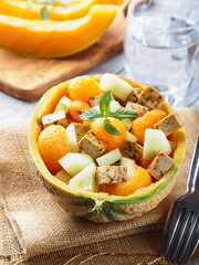 Vegan cantaloupe melon salad with tofu cheese, herbs and cucumber. Healthy summer fresh lunch