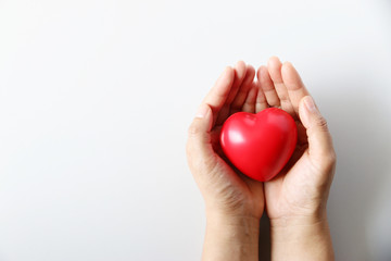 Fototapeta premium I love you Mom red heart ball in hand,wood background: Nursing children home concept: Hospital medical business