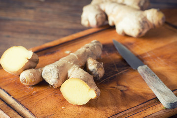 Ginger root sliced on wooden table