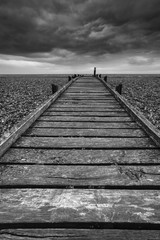 Concept image of path to nowhere in desolate beach black and white landscape