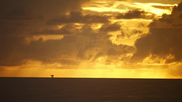 Dramatic sunset offshore in the middle of ocean
