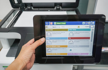 close up employee use office printer machine for scanning business documents