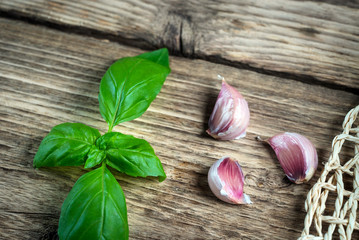 Garlic, basil and tomatoes on rustic table