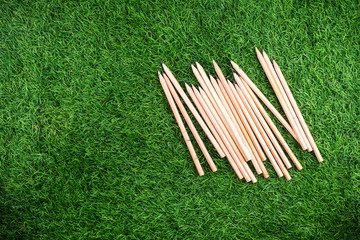 Education concept, Mobile phone with equipment and supplies for work on grass background.