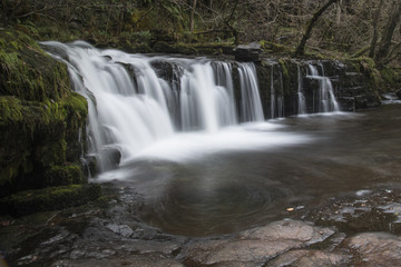 Stunning watefall landscape in cross over between Autumn and Winter with Fall colour