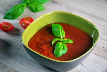 fresh bio tomato soup in a green bowl