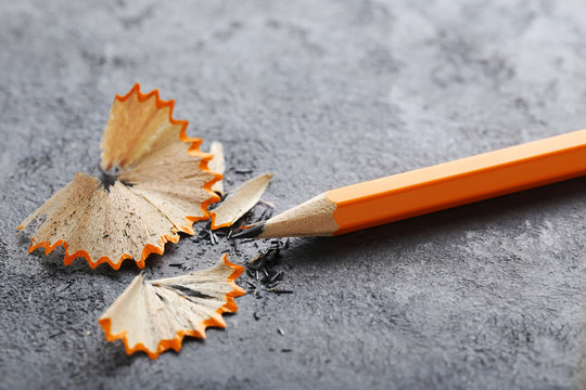 Yellow Pencil With Shavings On Grey Background