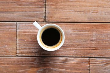 Cup of coffee on a brown wooden table