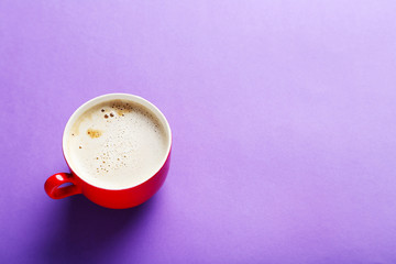 Cup of coffee on a purple background