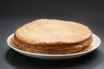 homemade blini stack on plate on slate board, traditional russian food