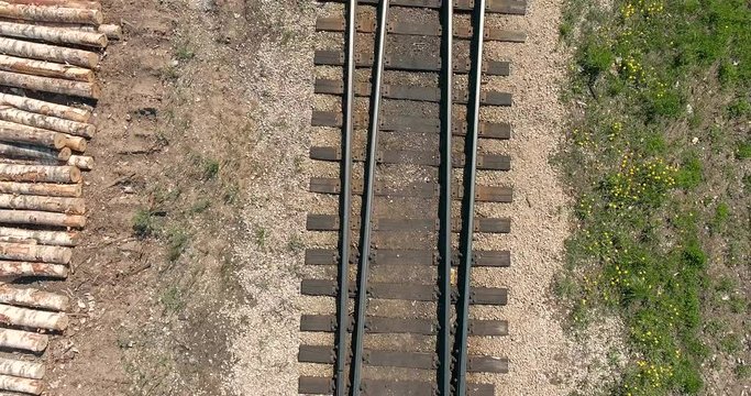 A railway and a train with wooden logs