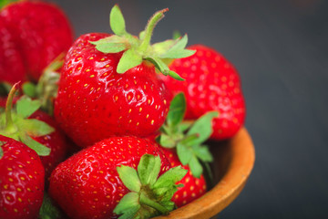 Ripe strawberries in a plate close-up.
