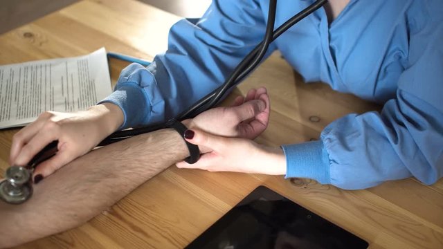 Female doctor measure blood pressure, close up 4k