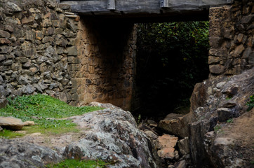 Dark tunnel under small wooden bridge