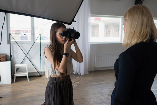 Girl photographer photographing model