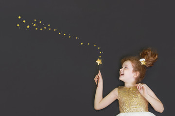 Cute princess girl dreaming on a  chalkboard background with gold star.