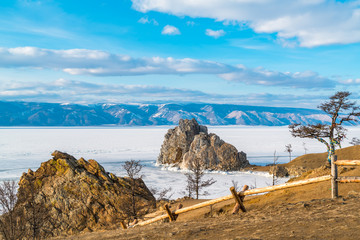 Rock Shamanka and holy tree at cape Burkhan on Olkhon Island in Lake Baika,l Russia