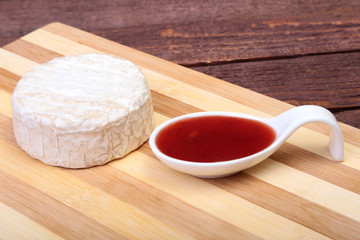Cheese with white mold. Camembert or brie type with Cranberry sauce.. Healthy breakfast.