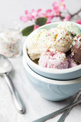 Mixed flavor ice cream scoops in bowl