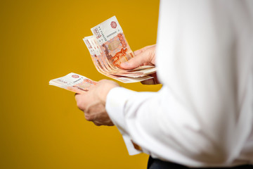 Closeup of businessman holds money. Banknotes Of Russia. Isolated