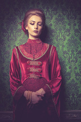 Beautiful Gorgeous woman dressed vintage clothes in retro interior. Rococo period. Luxury and high class