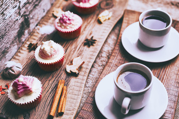 Cupcake and coffee on old dark rustic wooden table