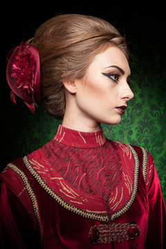 Portrait of gorgeous woman dressed vintage clothes in retro interior. Rococo period. Luxury and high class