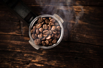 Fresh coffee beans in coffee maker.