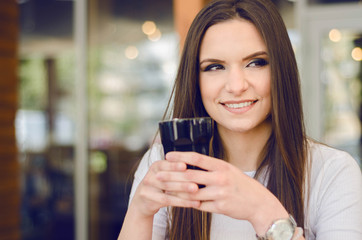 Portrait of attractive young european woman drinking coffee