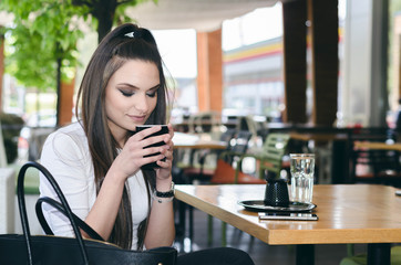 young teenager drinking coffee and looking in the cup