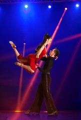 Couple ballroom dancing on illumination © Andrey Burmakin